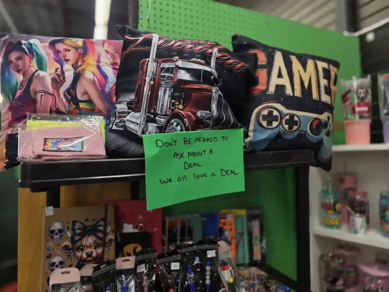 Graphic pillows and ask-about-a-deal sign at Glowing Creations