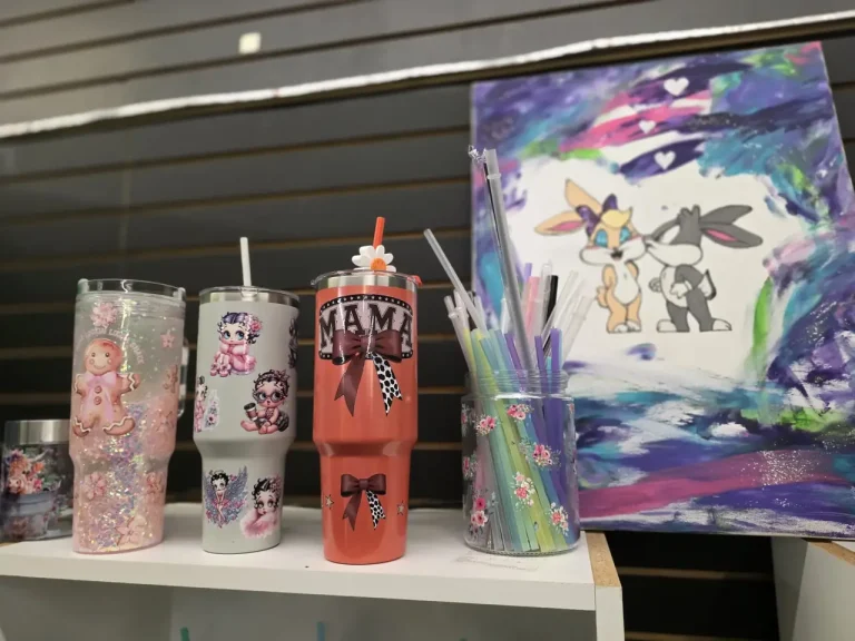 Colourful tumblers and artwork displayed at Glowing Creations